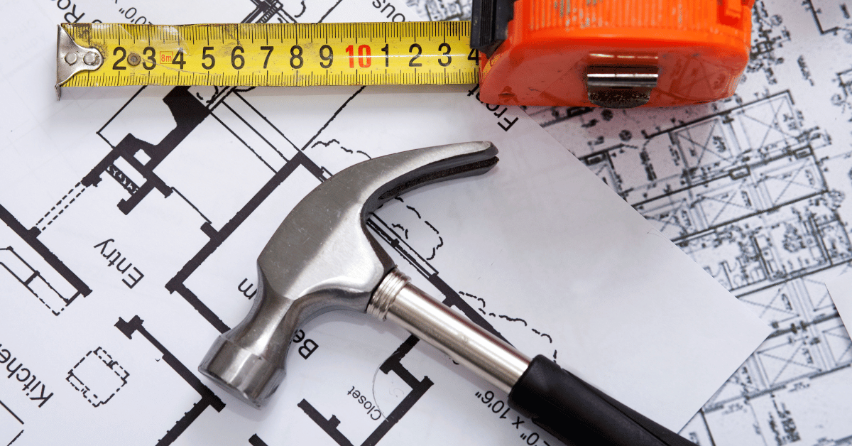 Hammer and measuring tape layer over Birmingham, Alabama contractor plans